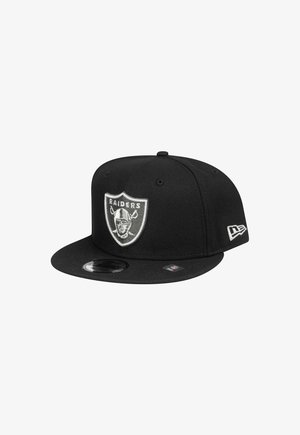 Black cap made of fabric with a flat brim. Features an embroidered Raiders logo on front and a small tag on the side.