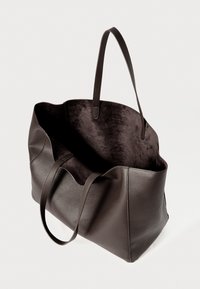 Dark brown leather tote bag with pebbled texture, open top, and two long handles, shown empty against a plain background.