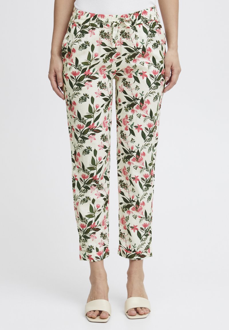 Pantalons fleuris avec une base crème, ornés de motifs botaniques roses et verts, dotés d'une taille élastique et d'une coupe décontractée.