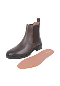 Brązowy skórzany botek Chelsea z elastycznymi bocznymi panelami, gumową podeszwą i pętelką do zakupu; zawiera wyjmowaną wkładkę z pomarańczowymi akcentami.