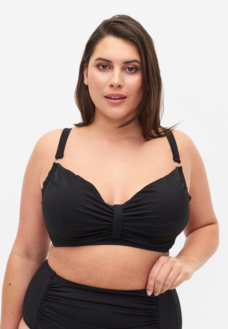 Svart bikiniöverdel med draperad design, justerbara remmar och mittknut. Materialet är slätt med en något glänsande yta.