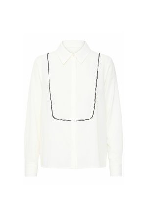 White button-up shirt with a pointed collar, featuring black decorative stitching around the chest area and long sleeves. Smooth texture.