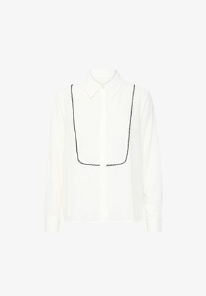 Fehér, gombos ing, hegyes gallérral, fekete díszítő varrással a mellrészen és hosszú ujjakkal. Simávállal.