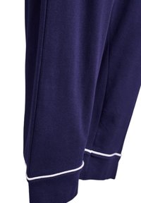 Navy blue joggers made of soft fabric with white piping accents at the cuffs, featuring a straight cut and smooth texture.
