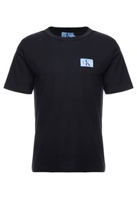 Svart bomullströja med korta ärmar, rund halsringning och ett litet blått och vitt logomärke på vänster bröst. Slät textur.