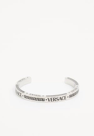Hopeakuviointi, jossa on "Versace"-logo kaiverrettuna nauhan varrelle, ja sitä korostaa geometrinen kreikkalainen avainkuvio. Suoraviivainen viimeistely.