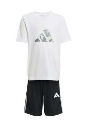 T-shirt blanche à manches courtes avec un logo adidas en camouflage gris, associée à un short noir avec des accents blancs et un petit logo adidas sur le côté.