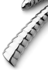 Metallisk, glänsande yta med en ribbad design; avlång form med växlande släta och texturerade sektioner.