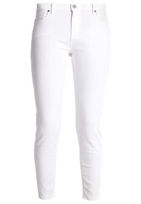 Jeans de mezclilla blanca con un corte ajustado, que cuentan con un diseño de cinco bolsillos, cierre de botón metálico y costuras mínimas. Textura suave en toda la prenda.