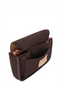 Kleine dunkelbraune Stoffhandtasche mit Klappenverschluss, Fronttasche und teilweise sichtbarem verstellbaren Riemen innen.