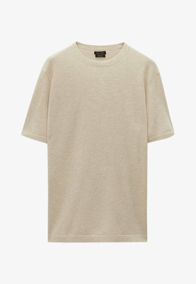 Light beige t-shirt made of textured fabric, featuring a round neckline and short sleeves, with a relaxed fit and minimal stitching details.