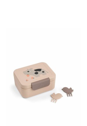 Lille beige madkasse med ko- og jordbærillustrationer, sikret med en brun spænde, ledsaget af to små fugleformede madpinde.