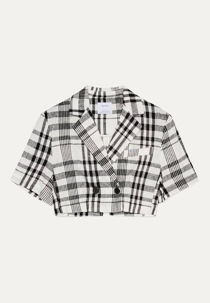 Blazer court à motif écossais noir et blanc, confectionné dans un tissu à texture marquée. Présente un design croisé à double boutonnage et des manches courtes.