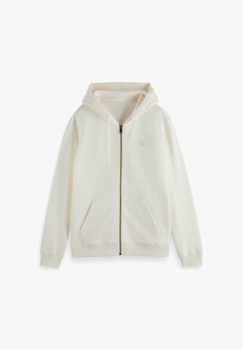 Sudadera cremosa con cremallera, capucha, mangas largas, bolsillos frontales y cordón ajustable. Textura suave y diseño minimalista.