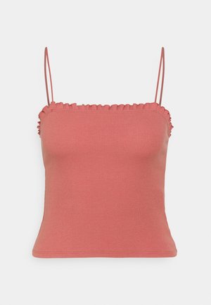 Haut court côtelé rose poussiéreux avec fines bretelles spaghetti et bordure volantée le long de l'encolure et des côtés, présenté sur un fond blanc.