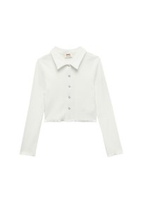 Camicia bianca cropped a maniche lunghe con colletto e chiusura frontale a bottoni. Realizzata in un materiale morbido e testurizzato. Presenta un orlo dritto.