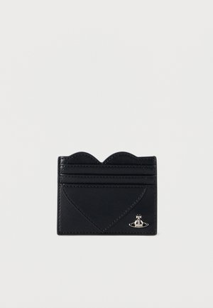 Black leather cardholder with a scalloped edge, heart-shaped design, four slots, and silver hardware accent featuring a crown and planet motif.