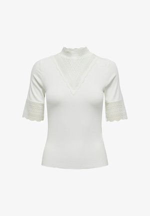 Blouse blanche cintrée à manches courtes avec col montant en dentelle, détail triangulaire en dentelle sur la poitrine et bordure en dentelle aux extrémités des manches.