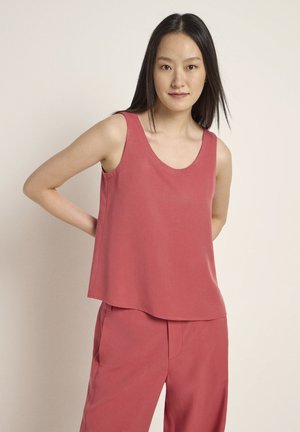 Ärmelloses, locker sitzendes Oberteil in Rosafarbe mit rundem Halsausschnitt. Hergestellt aus leichtem Stoff mit glatter Textur und ohne sichtbare Muster.