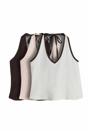 Three sleeveless V-neck crop tops with tie straps at the back in white, light pink, and dark brown, layered side by side.