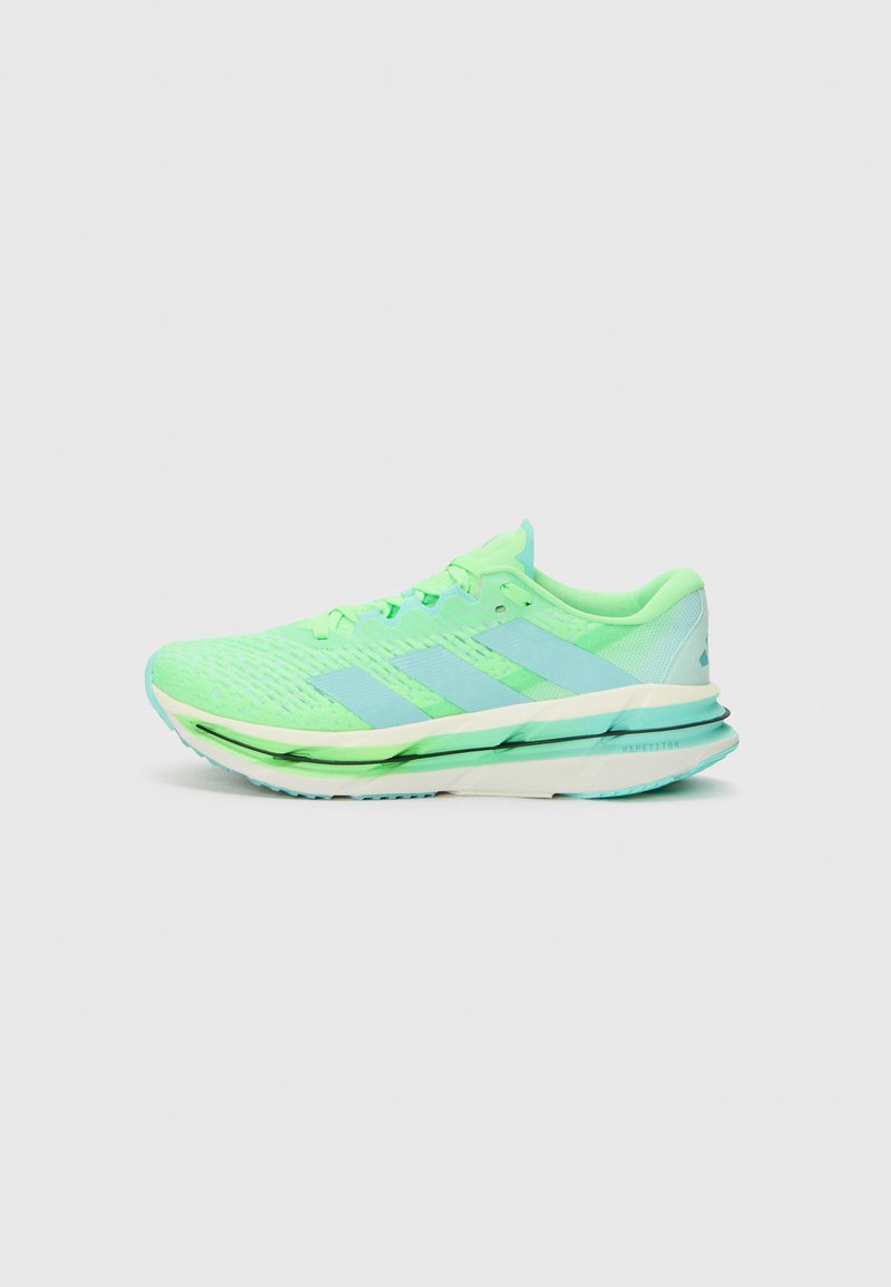 Light green athletic shoe featuring a breathable mesh upper, three blue stripes, and a cushioned sole with a transparent heel section.