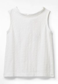 Haut blanc sans manches avec motif à points texturés et encolure ronde sur fond blanc uni.