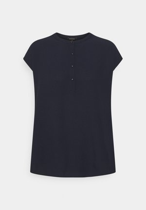 Blouse bleu marine à manches courtes avec un col rond et quatre petits boutons au centre devant.