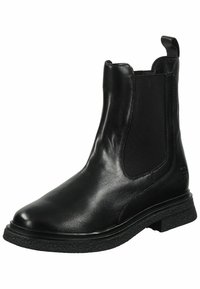 Bota de tobillo de cuero negro con panel lateral elástico, punta redondeada, suela de goma texturizada y un sutil logotipo en el lado. Acabado suave.