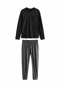 Zwarte lange mouwen shirt met een borstzak, gecombineerd met grijze sweatpants met een drawstring, elastische manchetten en zijzakken. Zacht materiaal.