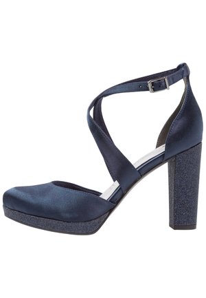 Chaussure à talon haut bleu marine avec finition satinée, talon carré pailleté, plateforme et brides croisées à la cheville avec une boucle argentée.