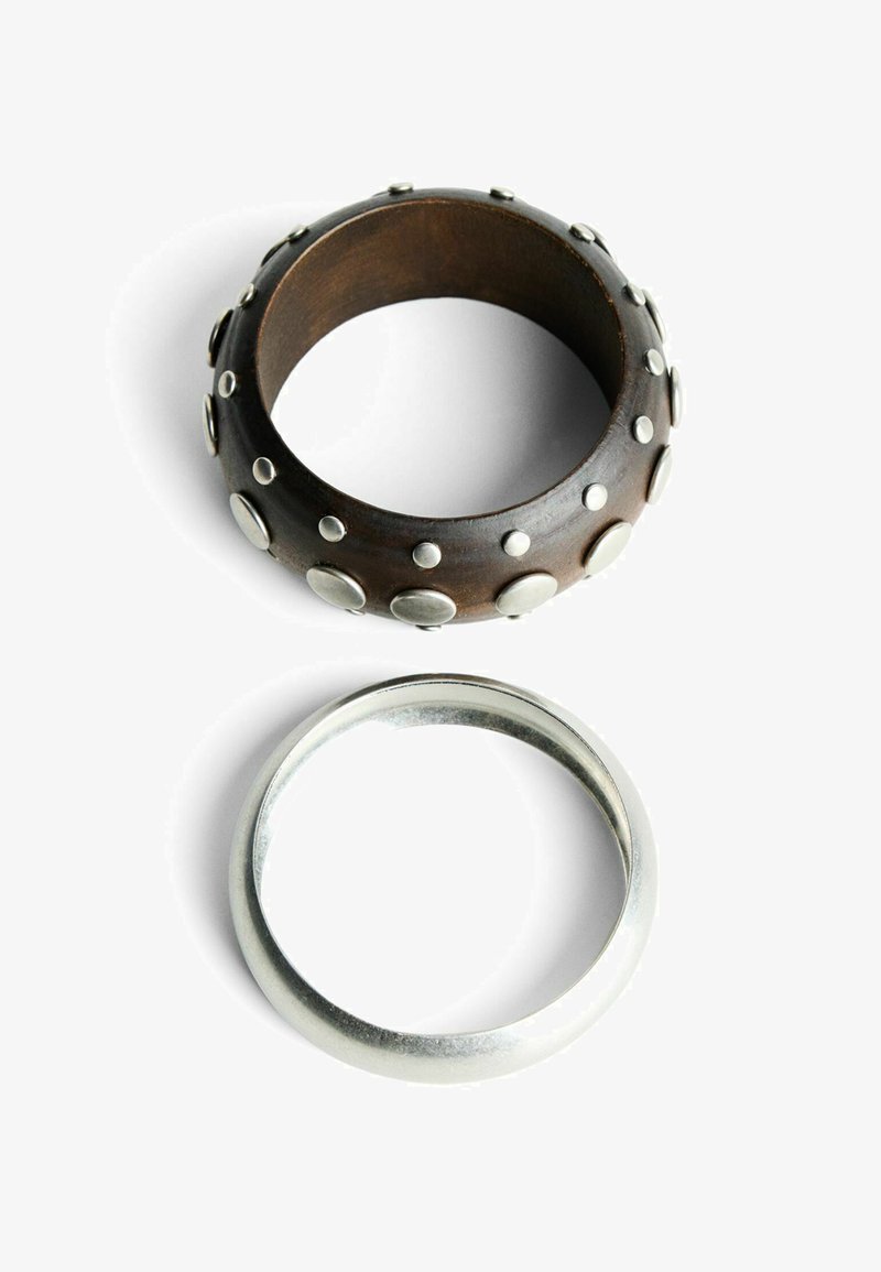 Wooden ring with metallic studs, dark brown color, textured surface. Silver-colored smooth band ring, simple design.