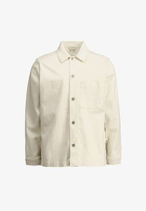 Hele beež värvi puuvillane särkjakk, millel on terav krae, ees nööpidega sulgur, üks rinnatasku ja väike logo aksent.