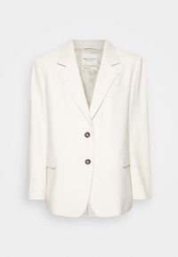Blazer cremoso testurizzato con una vestibilità su misura. Presenta rever strutturati, due tasche frontali e due bottoni scuri. Interno foderato.