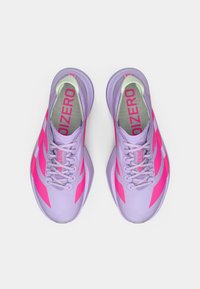 Lila Sportschuhe mit pinken Akzenten, ausgestattet mit einem strukturierten Obermaterial, rundem Design, Schnürverschluss und gepolsterter Sohle für Unterstützung.