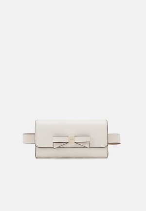 Light beige leather bag featuring a bow accent, flap closure, and a gold-tone hardware logo. Includes two side straps. Smooth texture.