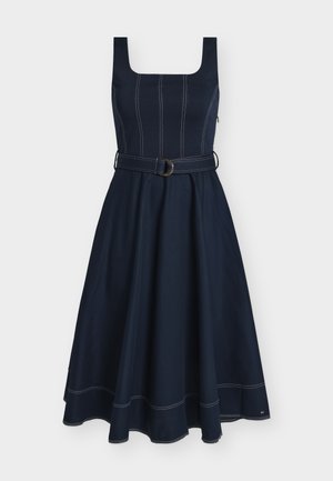 Sleeveless navy blue midi dress with square neckline, fitted bodice, white contrast stitching, flared skirt, and matching belt with metal buckle.