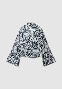 Black and white floral patterned blouse with long, flared sleeves and a collar, featuring a smooth, shiny texture and a cropped design.