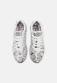 White sneakers with black doodle patterns, featuring lace-up design, cushioned tongue, and inner lining with colorful print accents.