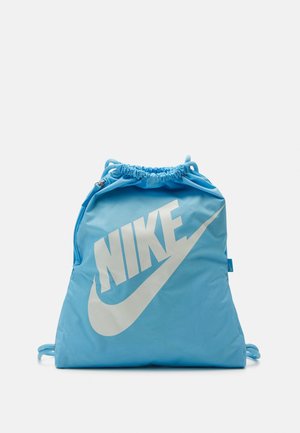 Sac à cordon Nike bleu clair avec grand logo blanc et swoosh à l'avant sur fond uni.