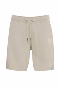 Shorts en coton beige avec une taille à cordon ajustable, des poches sur les côtés et un motif graphique subtil en forme de cœur sur le bas gauche.