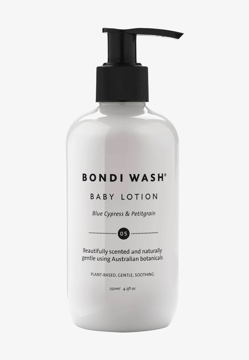 Bouteille blanche avec pompe noire, étiquetée "Bondi Wash Baby Lotion", présentant un texte et des détails en noir. Taille : 250 ml, avec une formule apaisante à base de plantes.