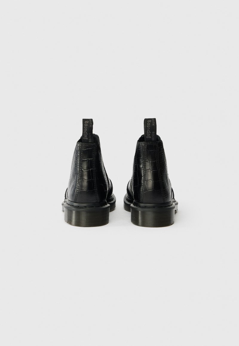 Sorte læderankelstøvler med krokodillemønster, struktureret finish og gummisåler. Har stikklapper for nem påtagning.