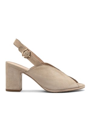 Beige mokasíny na podpätku so slingback strihom, otvorenou špičkou a okrúhlym, hrubým podpätkom. Majú nastaviteľný remienok so zlatou prackou.