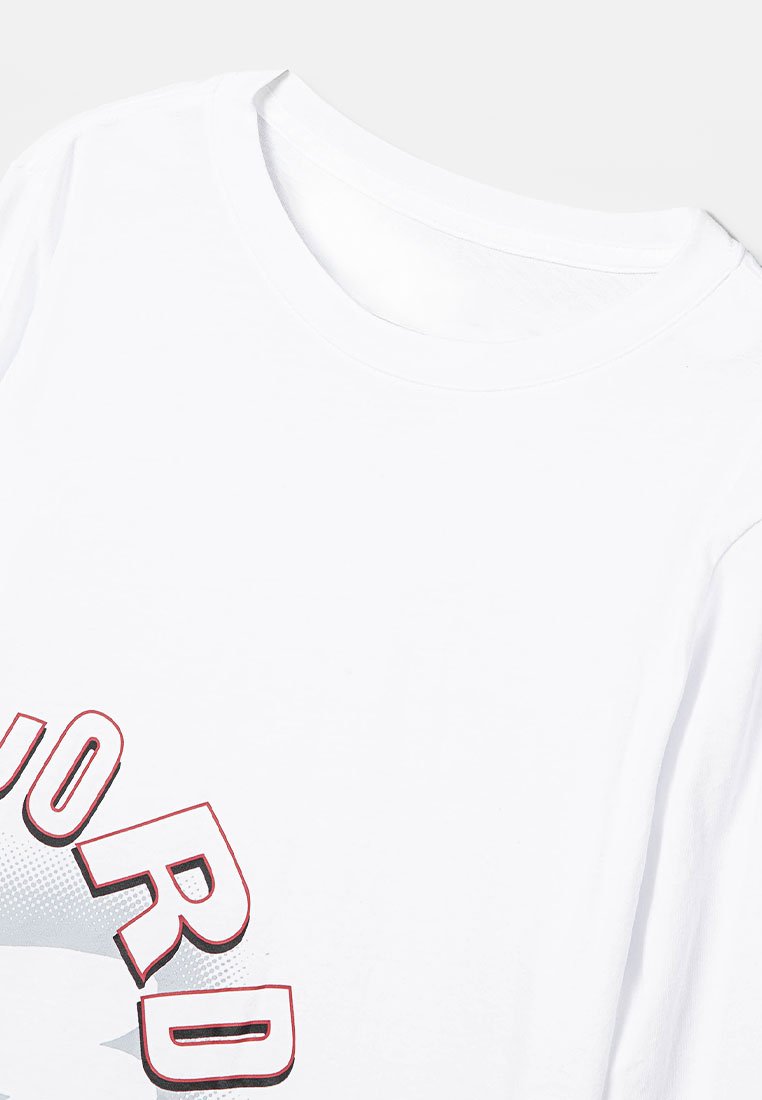 Camiseta blanca con cuello redondo, que presenta un diseño gráfico en rojo y negro en la parte delantera. Textura de tejido suave, ajuste estándar.