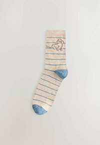 Beige och blå randig strumpa med en ljusblå tå, med en broderad hunddesign på bendelen. Mjuk textur och normal passform.