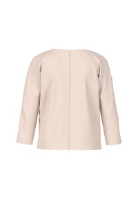 Light beige, long-sleeve top with a round neckline. Features a simple design, smooth texture, and contrasting stitching down the back.