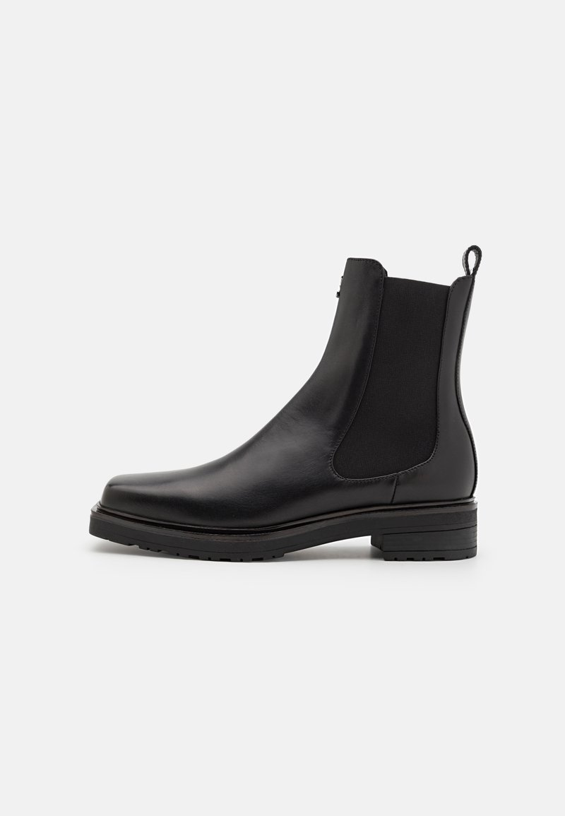 Black leather ankle boot with elastic side panels, a low stacked heel, and a pull tab on the back. Smooth texture and sleek design.
