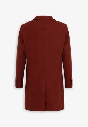 Rust-colored coat with a herringbone texture, single vent at the back, and a notched collar. Long sleeves with buttoned cuffs.