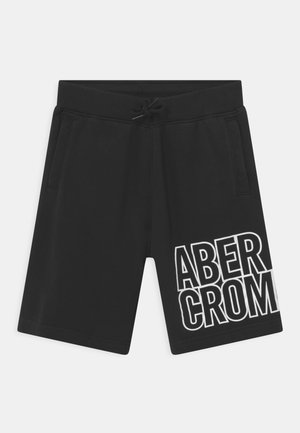 Pantalones cortos casual negros con bolsillos laterales y cintura con cordón, con texto grande blanco delineado "ABERCROMBIE" en la pierna derecha.