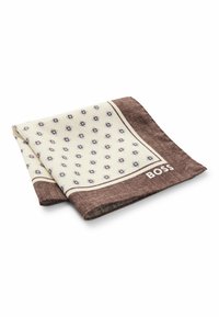 Brown and cream patterned pocket square with geometric designs, finished edges, and logo in the corner. Made from a textured fabric.